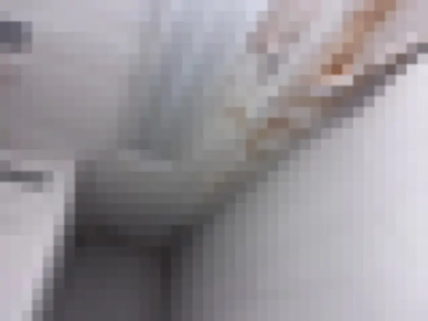 White ceiling has detached finish and brown stains beside light fixture and block wall