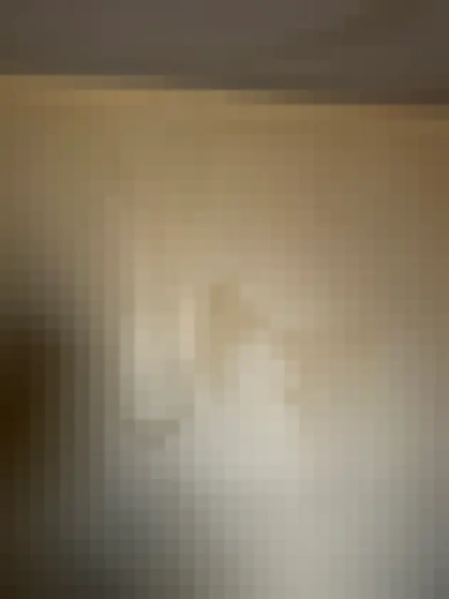 Light wall has broad vertical blistering or peeling finish near ceiling
