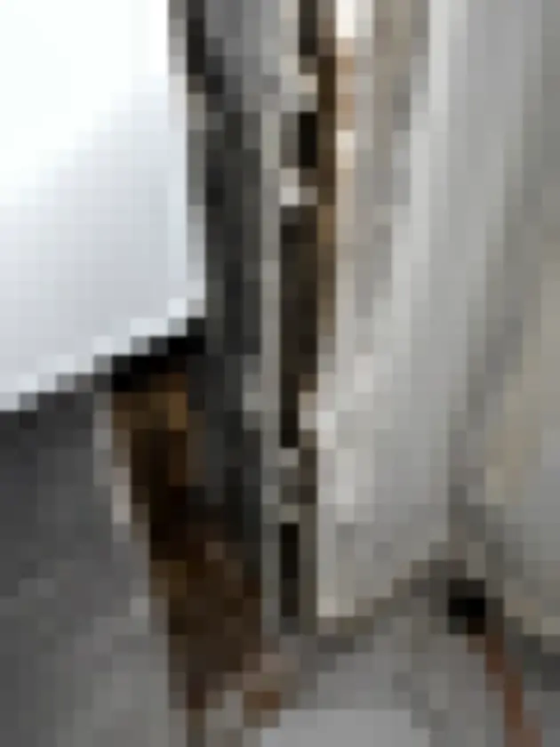 Close-up of scraped and marked wall trim next to metal ventilation grille