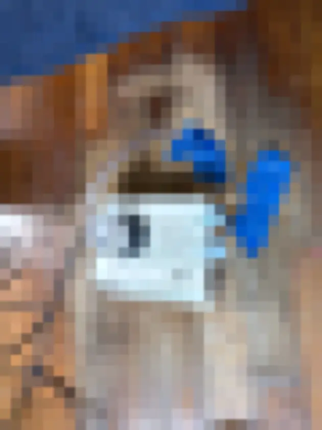 Photograph showing portable sampling pump and coiled tube on an indoor wood floor, held with blue tape