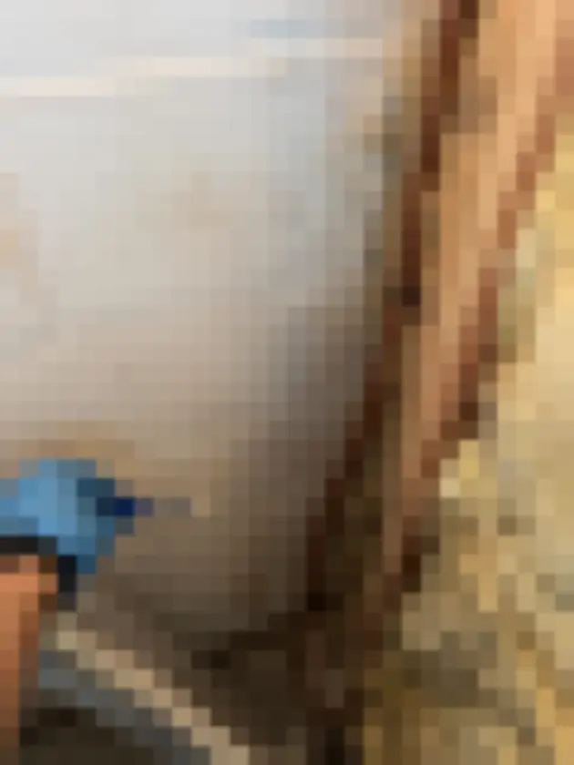 Gloved hand taking a swab from a painted block wall